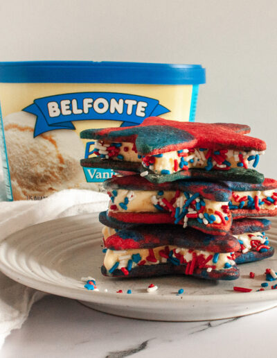red white and blue cookie on a plate with carton of Belfonte ice cream in background